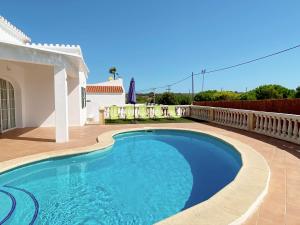 a swimming pool in the backyard of a house at Villa Vergara in Cala en Porter
