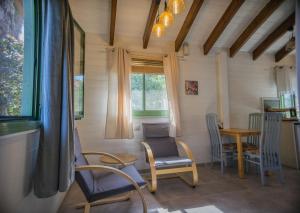Zimmer mit Stühlen, einem Tisch und einem Fenster in der Unterkunft Provence in the Valley in Kefar Barukh