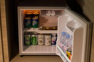 an open refrigerator filled with drinks and soda at Retro39 in Bangkok +30 photos