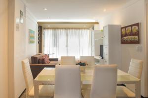a dining room and living room with a table and chairs at Flat Natal - Localização TOP e WIFI in Natal