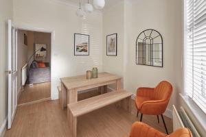 a living room with a table and a chair at Host & Stay - Fountains Cottage in Guisborough
