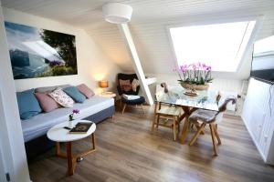 a living room with a couch and a table at ALP APARTMENTS centre location with traditional design and self check-in in Engelberg