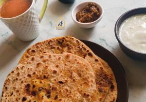 a tortilla is sitting on a plate on a table at Baddi Guest House in Baddi +9 photos