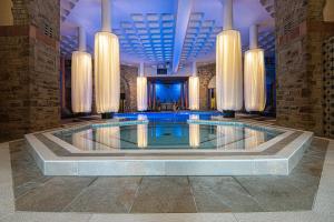 a large swimming pool in a large room at Shrigley Hall Hotel in Macclesfield