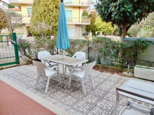 a table and chairs with an umbrella on a patio at M278 - Marcelli, delizioso bilocale con terrazzo in Marcelli