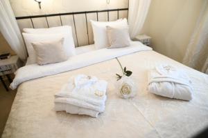 a hotel room with two towels on a bed at Garni Hotel Dash in Novi Sad