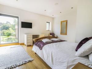 a bedroom with a bed and a desk and a window at Finest Retreats - Oak House in Tealby