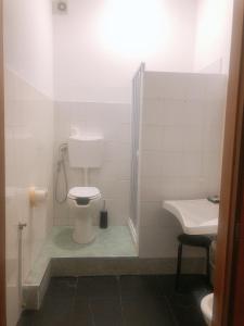 a bathroom with a toilet and a sink at NEW FAMILY INN in Pero