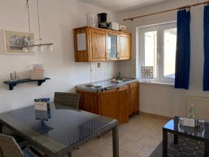 a kitchen with a table and a sink and a counter at Apartment Gartenstrasse 3 in Ostseebad Sellin