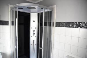 a shower with a glass door in a bathroom at Apartment Gartenstrasse 3 in Ostseebad Sellin