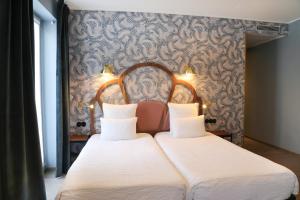 Letto o letti in una camera di Hotel André Latin