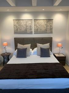 um quarto com uma cama grande e 2 candeeiros em TiAMo Modern Design Guest House em Ronchi dei Legionari
