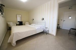 Postel nebo postele na pokoji v ubytování Garni Hotel Dash