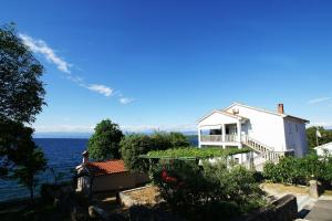 a white house with a view of the water at Apartment Andrina in Vantačići
