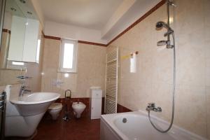 a bathroom with a tub and a sink and a toilet at Apartment Andrina in Vantačići +18 photos