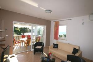 a living room with a couch and a table at Apartment Andrina in Vantačići