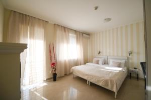 Postel nebo postele na pokoji v ubytování Garni Hotel Dash