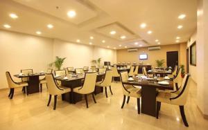 a large dining room with long tables and chairs at Five Elements Hotels The Claire in Gurgaon