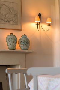 two vases sitting on a shelf next to a lamp at Cascina Margherita - Marchesi Alfieri in San Martino Alfieri