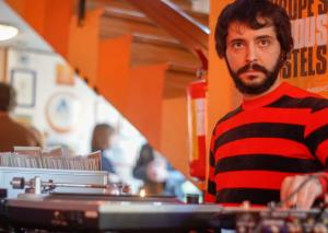 a man in a red and black striped shirt at Sunflower Beach Backpacker Hostel in Rimini