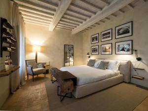 a bedroom with a bed and a desk and a chair at Argiano Dimore Wine Relais in Argiano
