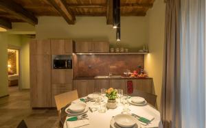 uma cozinha com uma mesa com pratos e copos de vinho em Villa Antica Dimora intera struttura - Homelike Villas em Deruta