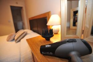 a hair dryer sitting on a table next to a bed at Chester Apartments in Chester