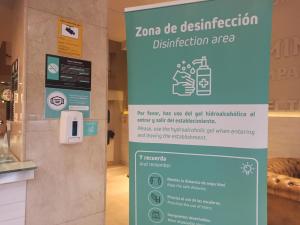 a sign for a disinfection sign in a store at Hotel Alda Ciudad de Soria in Soria