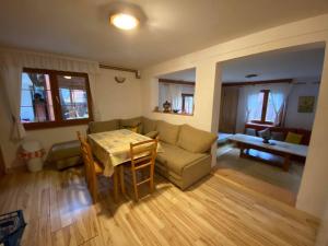 a living room with a couch and a table at Vikendica ABASA Vlašić in Vlasic