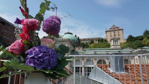 a bouquet of flowers on a balcony with a building at Hotel Bischoff in Baden-Baden