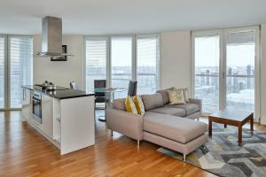 a living room filled with furniture and a window at SACO Canary Wharf - Trinity Tower in London