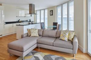 a living room with a couch and a coffee table at SACO Canary Wharf - Trinity Tower in London