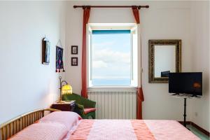 a bedroom with a window and a bed and a television at Terrazza Morgera by Napoliapartments in Ischia
