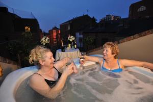 two women in a hot tub with glasses of wine at Chester Apartments in Chester