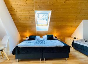 a bedroom with a bed with a wooden ceiling at Willa Leśna in Zakopane