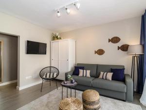 a living room with a couch and a table at Sitges Spaces Deluxe Centre Apartment in Sitges