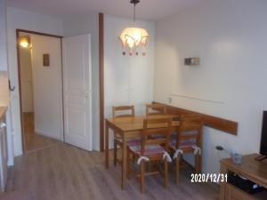 a dining room with a wooden table and chairs at Hébergement Coup de Coeur in Ax-les-Thermes +11 photos