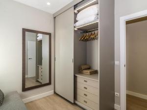 a dressing room with a mirror and a dresser at Sitges Spaces Deluxe Centre Apartment in Sitges +29 photos