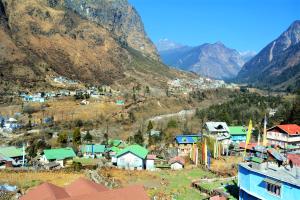 a small town in a valley with mountains in the background at Rufina Lachung de'CROWN in Lachung +38 photos