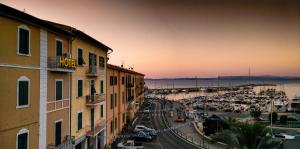 a view of a city with a harbor and a street at Hotel Alfiero in Porto Santo Stefano