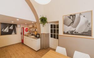 a kitchen with a refrigerator and a table in a room at Hotel Alfiero in Porto Santo Stefano