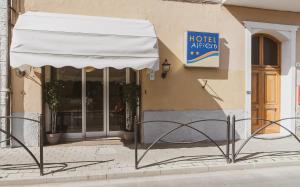 a hotel entrance with a white awning in front of a building at Hotel Alfiero in Porto Santo Stefano