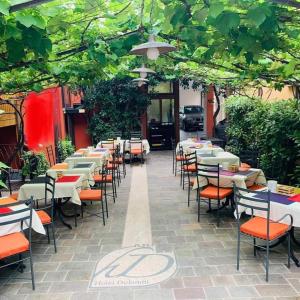 a row of tables and chairs in a restaurant at Hotel Dolomiti in Malcesine