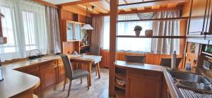 a kitchen with a sink and a desk with a chair at Appartement Koller in Pertisau