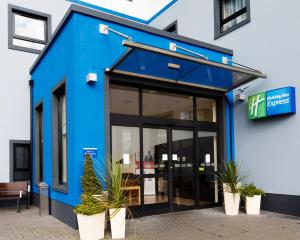 a blue and white building with a large window at Holiday Inn Express Antrim, an IHG Hotel in Antrim