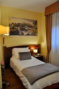 Postel nebo postele na pokoji v ubytování Hotel Hermitage