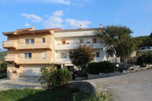 a large white building with a balcony at Apartments Josip 2830 in Rab