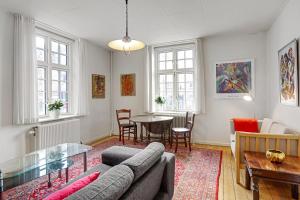 a living room with a couch and a table at Viborg Byferie in Viborg