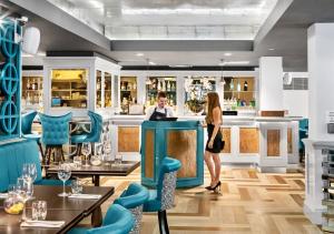 a man and a woman standing at a bar in a restaurant at The West Park Hotel in Harrogate