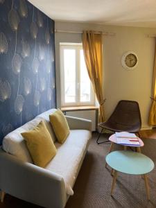 a living room with a couch and a window at L'escale Granvillaise in Granville